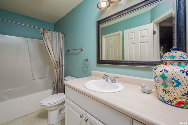 bathroom with tile patterned floors, vanity, toilet, shower / bath combo with shower curtain, and a textured ceiling