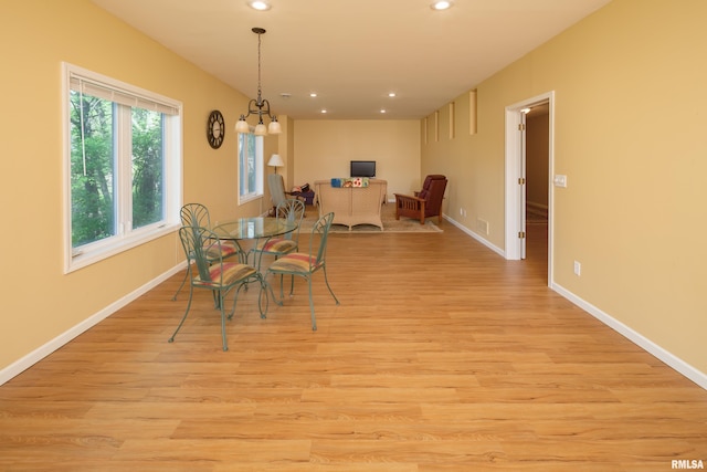 dining space with light wood-type flooring, recessed lighting, and baseboards