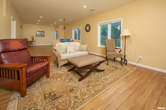 living area with wood finished floors, baseboards, and recessed lighting