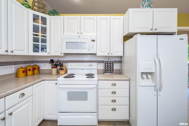 kitchen featuring white appliances, white cabinets, glass insert cabinets, and tasteful backsplash