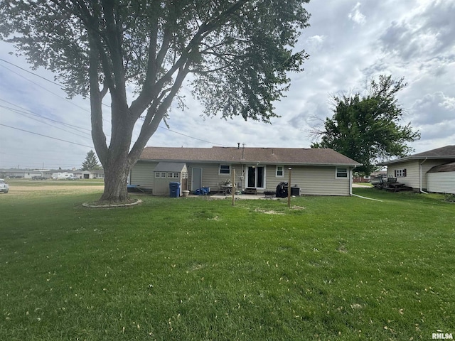 back of property with a lawn