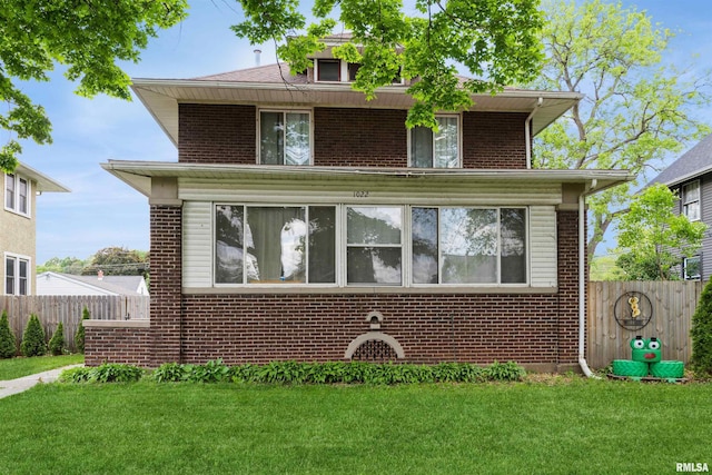 american foursquare style home featuring brick siding