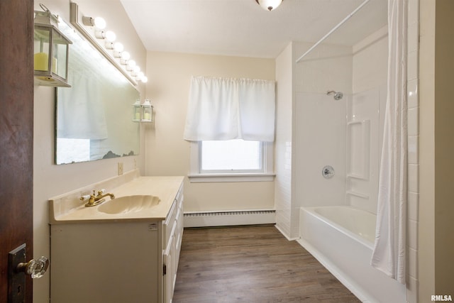 bathroom featuring a baseboard heating unit, wood finished floors, shower / bath combo, and vanity