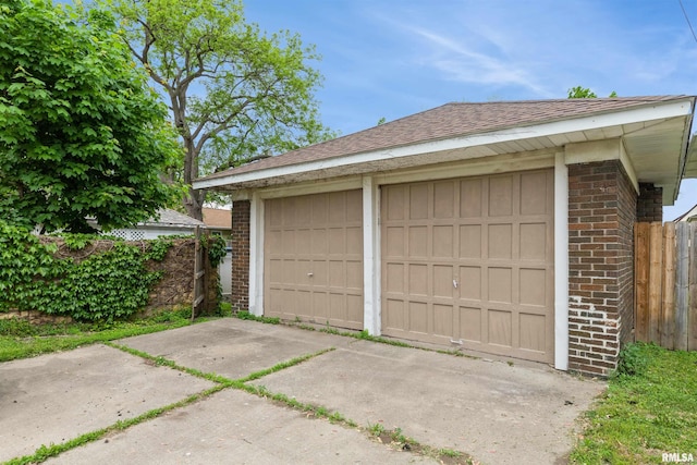 detached garage featuring fence