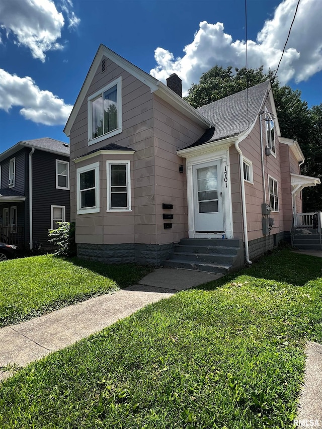 1701 2nd St, Moline, IL 61265 - view of front facade featuring a chimney and a front yard