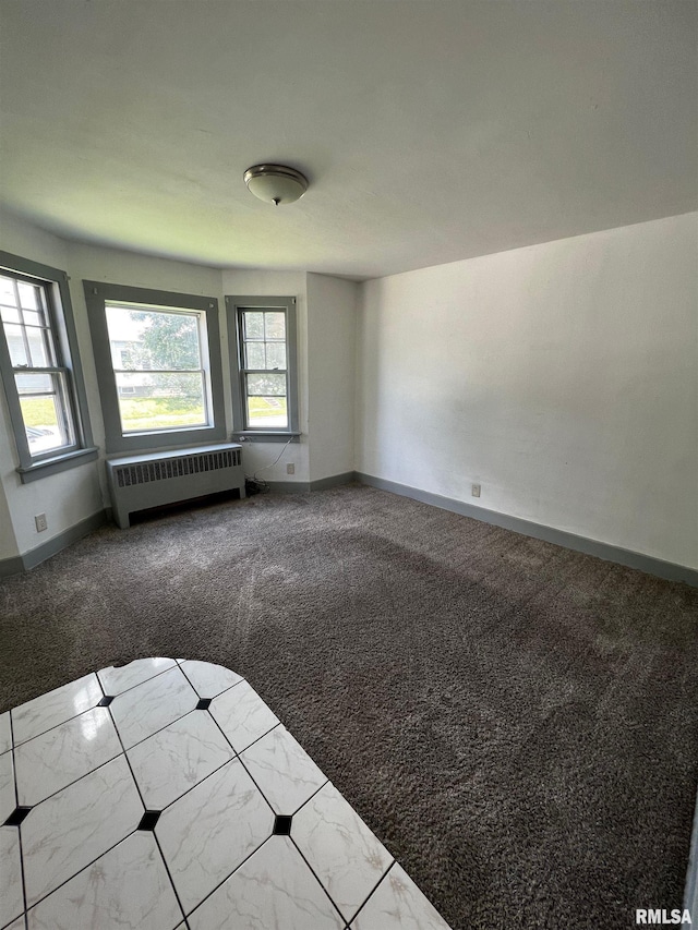 1701 2nd St, Moline, IL 61265 - carpeted empty room featuring radiator heating unit and baseboards