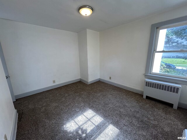 1701 2nd St, Moline, IL 61265 - carpeted spare room with radiator heating unit and baseboards
