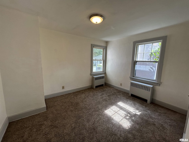 1701 2nd St, Moline, IL 61265 - unfurnished room featuring radiator heating unit, carpet flooring, and baseboards