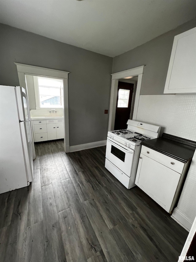 243 44th St, Moline, IL 61265 - kitchen featuring white appliances, white cabinetry, and dark wood-style flooring