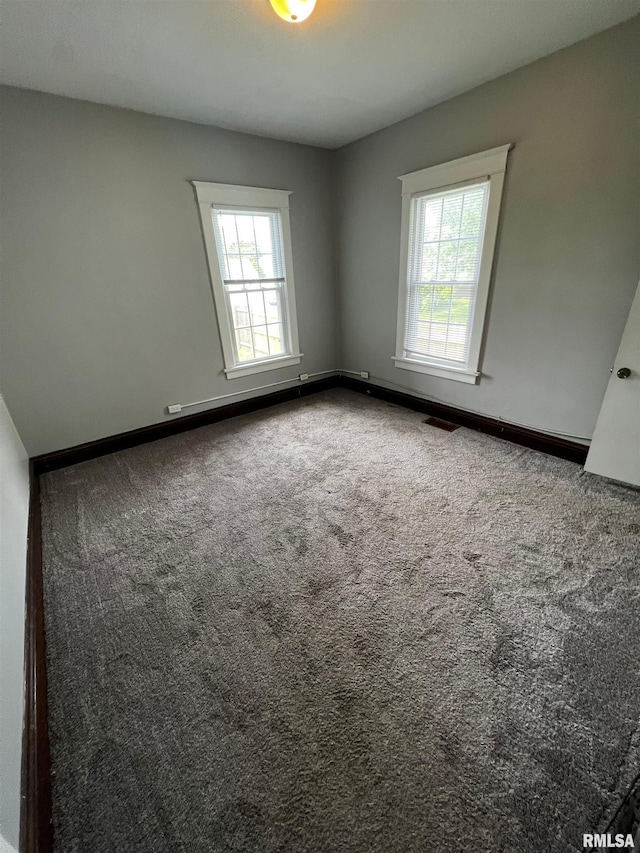 243 44th St, Moline, IL 61265 - carpeted empty room with baseboards