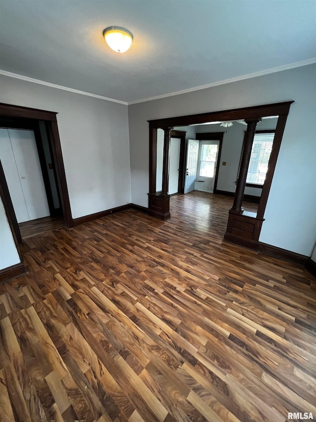 243 44th St, Moline, IL 61265 - empty room featuring dark wood-style flooring, crown molding, and baseboards