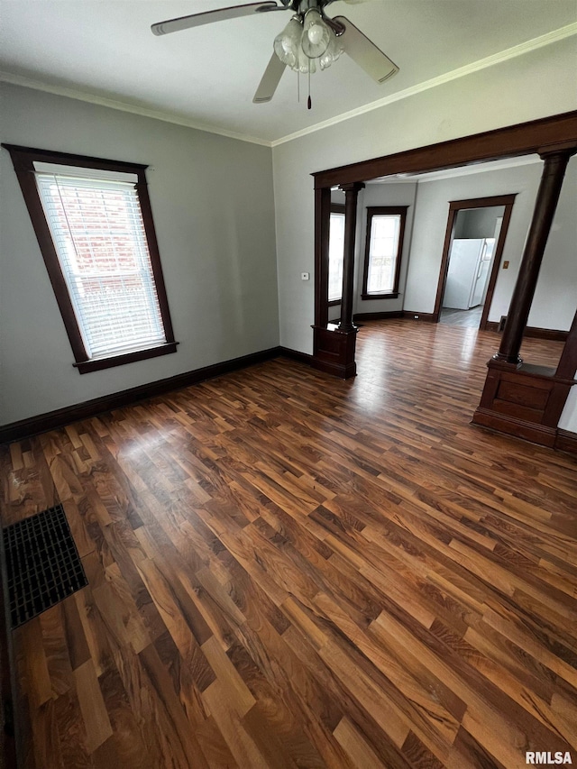 243 44th St, Moline, IL 61265 - empty room with dark wood-style flooring, baseboards, crown molding, and a ceiling fan