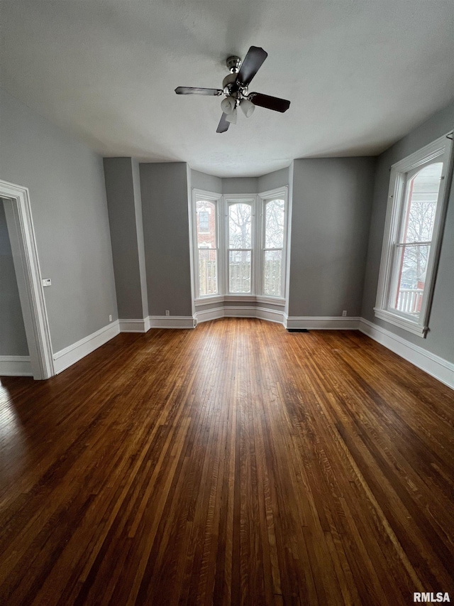 724 W 8th St, Davenport, IA 52804 - empty room with baseboards, dark wood finished floors, and ceiling fan