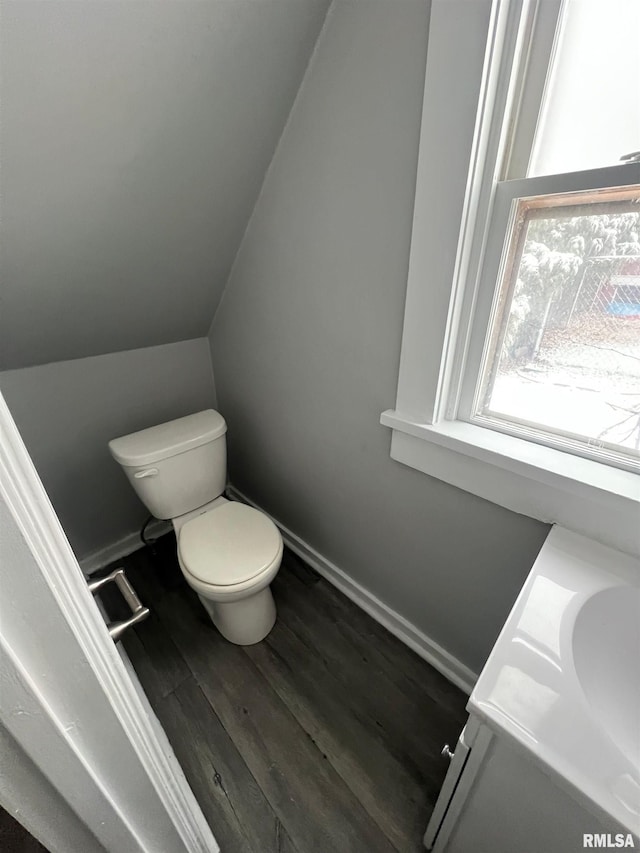 724 W 8th St, Davenport, IA 52804 - bathroom with toilet, wood finished floors, baseboards, and vaulted ceiling