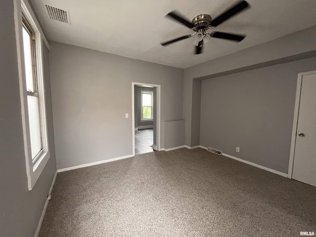 1627 W 4th St, Davenport, IA 52802 - carpeted empty room with a ceiling fan and baseboards