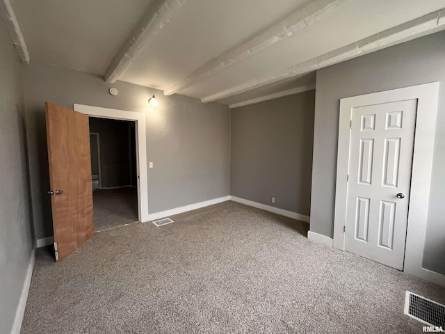 1627 W 4th St, Davenport, IA 52802 - unfurnished bedroom with carpet flooring, beam ceiling, and baseboards