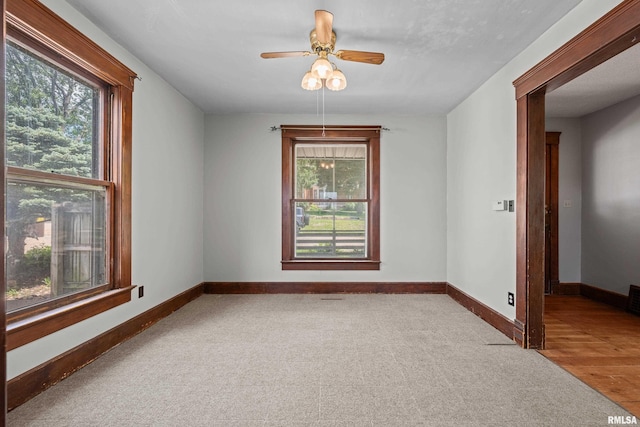spare room with carpet floors, baseboards, and ceiling fan
