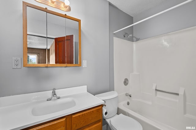 full bath featuring a textured ceiling, vanity, toilet, and shower / bath combination
