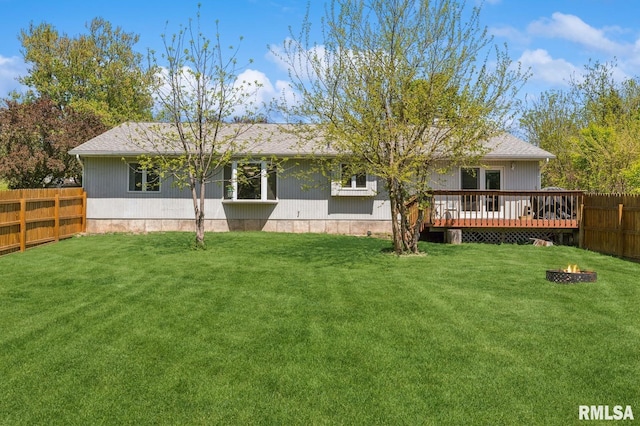 back of house with an outdoor fire pit and a deck