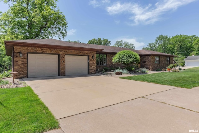 view of front of home featuring brick siding, concrete driveway, an attached garage, and a front lawn
