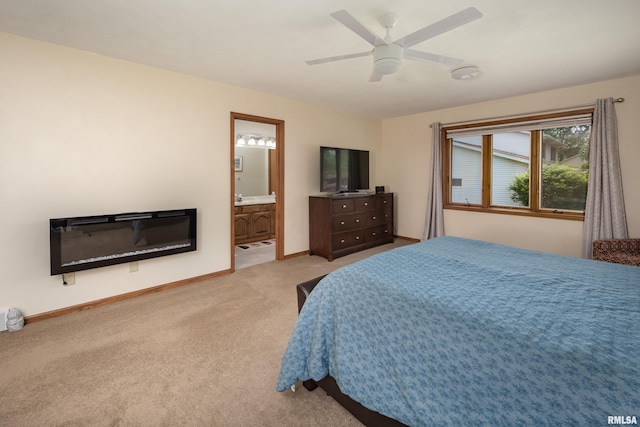 bedroom featuring carpet flooring, baseboards, ceiling fan, and connected bathroom