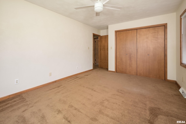 unfurnished bedroom featuring carpet flooring, baseboards, a closet, and ceiling fan