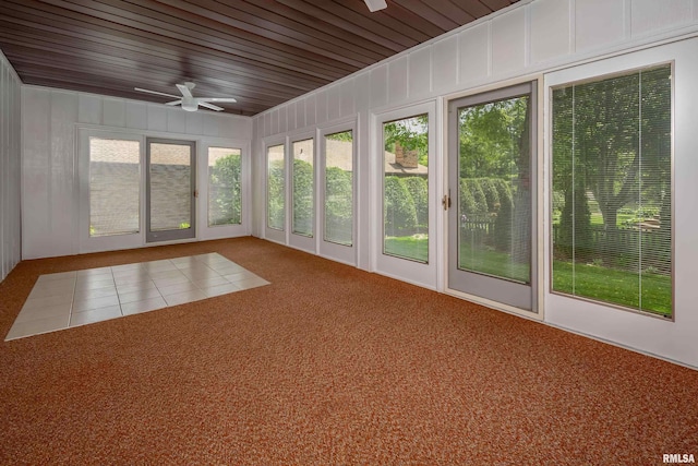 unfurnished sunroom with carpet and wood ceiling