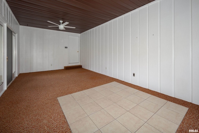 unfurnished room featuring light carpet and a ceiling fan