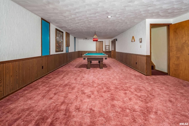 game room with a wainscoted wall, pool table, a textured ceiling, wooden walls, and carpet
