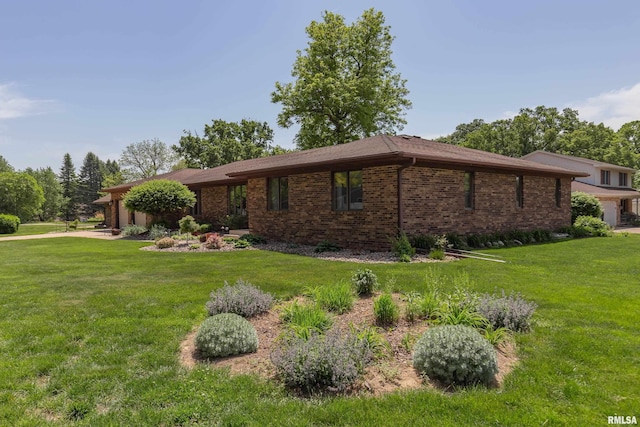 view of home's exterior with a garage, a lawn, and brick siding