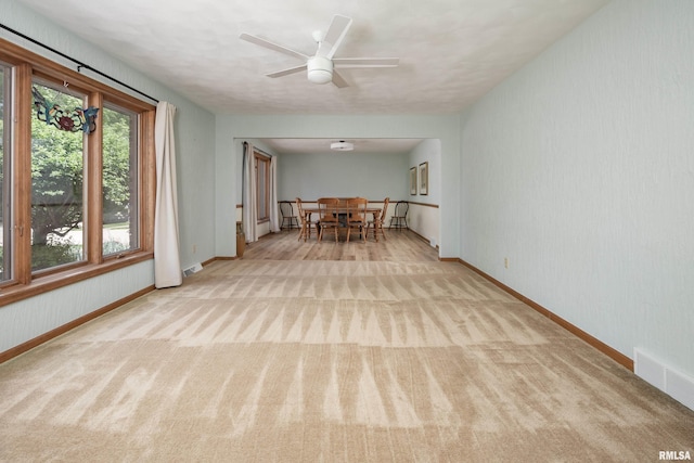 dining space featuring carpet, baseboards, and ceiling fan