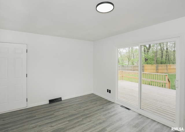 unfurnished room featuring wood finished floors and baseboards