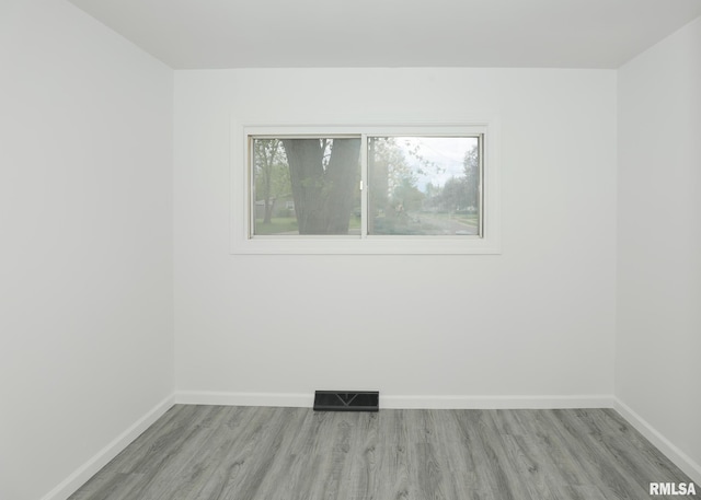 unfurnished room featuring light wood finished floors and baseboards