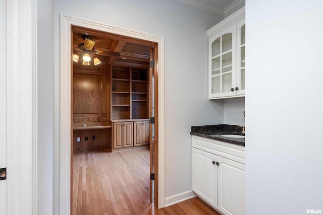 6800 Ridges Ct, Bettendorf, IA 52722 - bar featuring crown molding, light wood-type flooring, ceiling fan, and baseboards