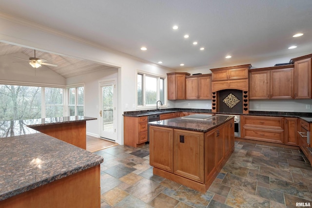 6800 Ridges Ct, Bettendorf, IA 52722 - kitchen with a sink, crown molding, brown cabinets, a center island, and stone tile flooring