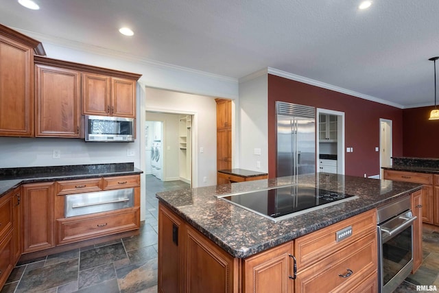 6800 Ridges Ct, Bettendorf, IA 52722 - kitchen with appliances with stainless steel finishes, a warming drawer, brown cabinetry, washing machine and clothes dryer, and ornamental molding