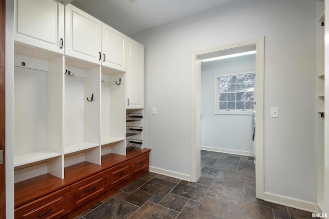 6800 Ridges Ct, Bettendorf, IA 52722 - mudroom with baseboards and dark stone finish flooring