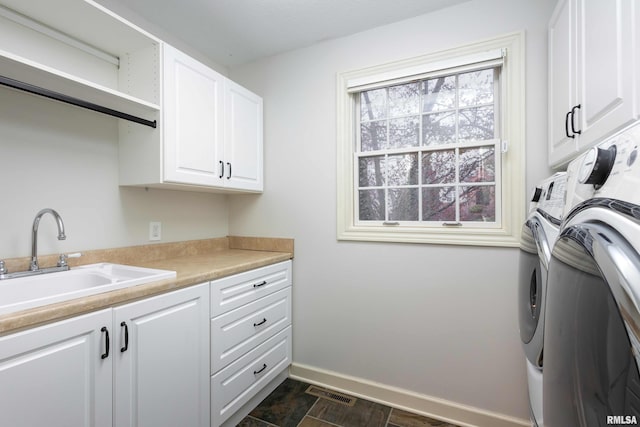 6800 Ridges Ct, Bettendorf, IA 52722 - clothes washing area with cabinet space, independent washer and dryer, and baseboards