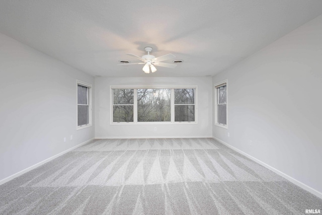 6800 Ridges Ct, Bettendorf, IA 52722 - unfurnished room with light colored carpet, baseboards, and ceiling fan