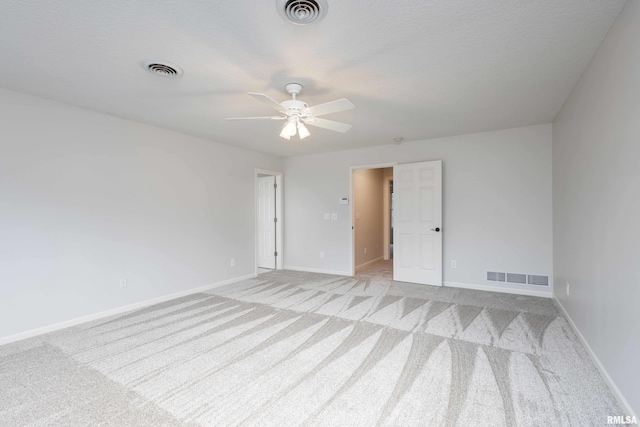 6800 Ridges Ct, Bettendorf, IA 52722 - empty room featuring light carpet, a ceiling fan, and baseboards