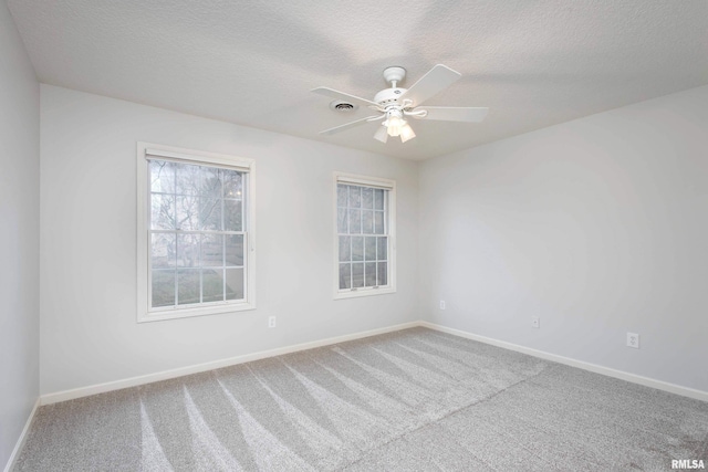6800 Ridges Ct, Bettendorf, IA 52722 - unfurnished room with carpet, baseboards, a textured ceiling, and ceiling fan