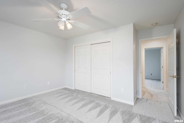 6800 Ridges Ct, Bettendorf, IA 52722 - unfurnished bedroom featuring carpet flooring, baseboards, a closet, and a textured ceiling