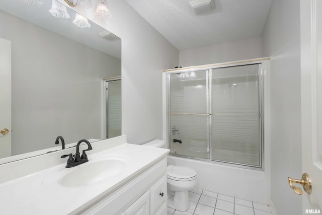 6800 Ridges Ct, Bettendorf, IA 52722 - bathroom featuring tile patterned floors, toilet, vanity, and bath / shower combo with glass door