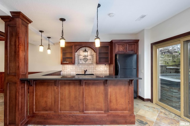 6800 Ridges Ct, Bettendorf, IA 52722 - bar area featuring backsplash, freestanding refrigerator, and pendant lighting