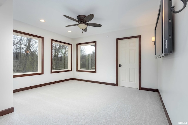 6800 Ridges Ct, Bettendorf, IA 52722 - spare room with light carpet, baseboards, ceiling fan, and recessed lighting