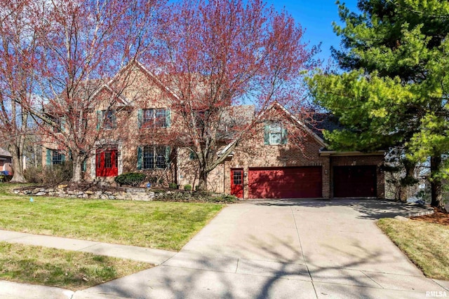 6800 Ridges Ct, Bettendorf, IA 52722 - view of front facade featuring concrete driveway, a front lawn, a garage, and brick siding