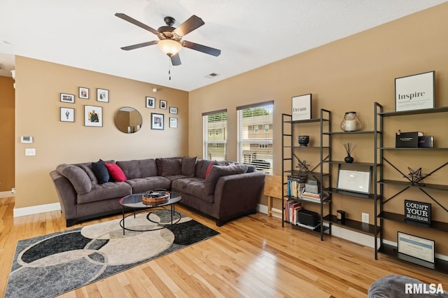 725 Cox Ct, Le Claire, IA 52753 - living room with wood-type flooring, ceiling fan, and baseboards