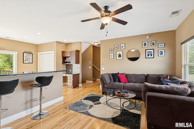 725 Cox Ct, Le Claire, IA 52753 - living room with plenty of natural light, light wood-type flooring, a ceiling fan, baseboards, and recessed lighting