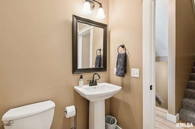 725 Cox Ct, Le Claire, IA 52753 - half bath with toilet, wood finished floors, and baseboards