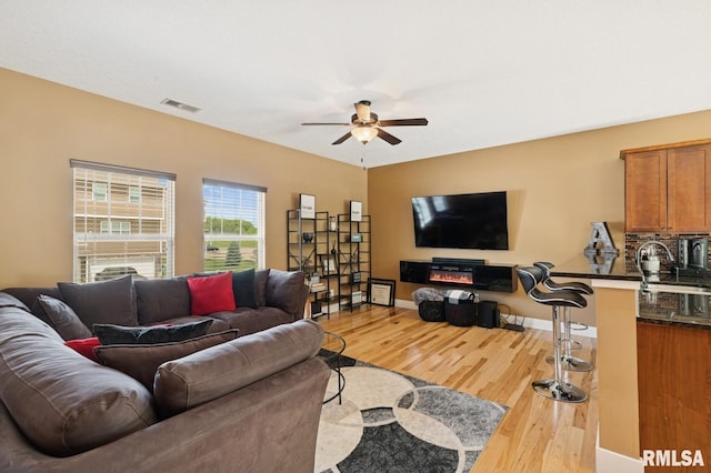725 Cox Ct, Le Claire, IA 52753 - living area featuring ceiling fan, light wood-type flooring, and baseboards